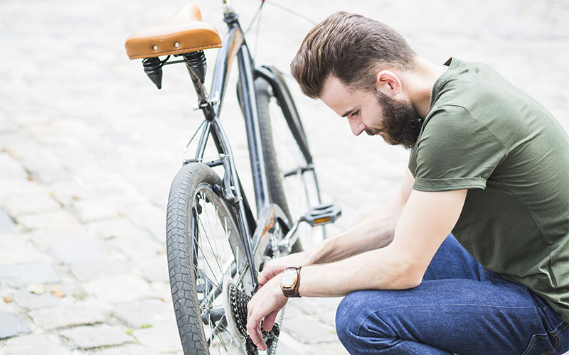 muž opravuje bicykel